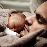 father holding baby